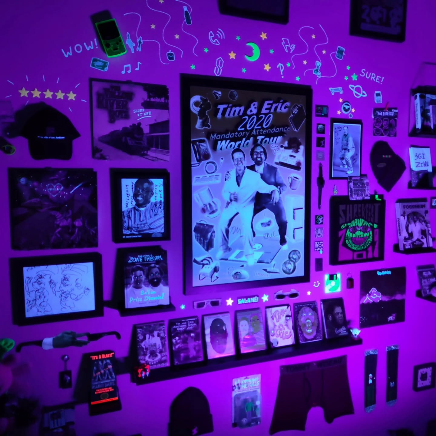 A wall of memorabilia bathed in blacklight